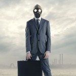 man in grey suit wearing gas mask