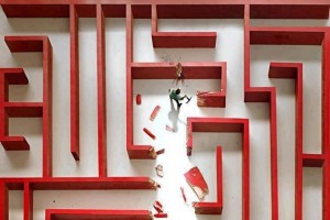 man breaking through maze