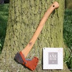 survival axe leaning on a tree