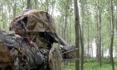 camo man with catapult