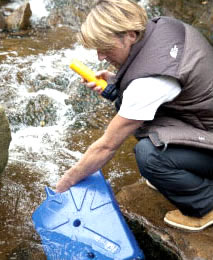 man filling a lifesaver jerry can